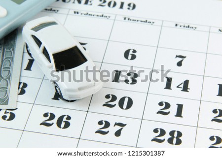 The white car on calendar background image close up.