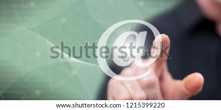 Man touching an e-mail concept on a touch screen with his finger