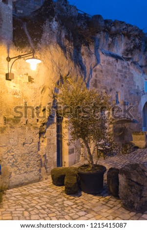Detail of narrow street and stone steps in the ancient town of Matera (Sassi di Matera), European Capital of Culture 2019,and UNESCO Heritage site and clouds, Basilicata Italy 