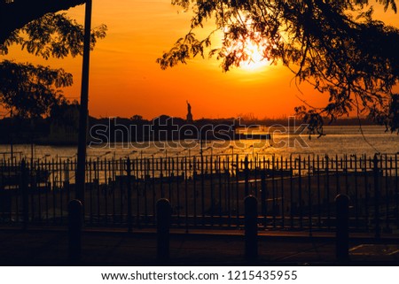 Statue of Liberty skyline at sunset, New York City. Panoramic view from Brooklyn