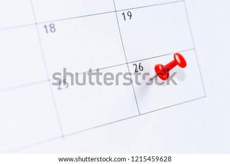 26 date on calendar with Red color pin. twenty-sixth day of month is marked with red thumbtack. Save the date.