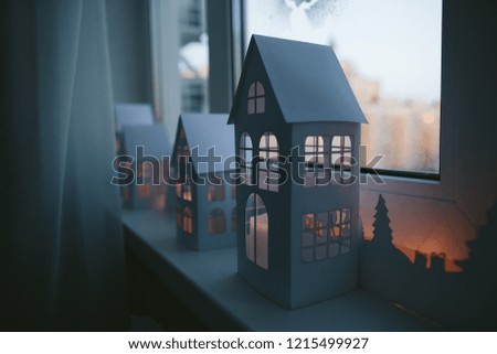 Paper winter city on windowsill