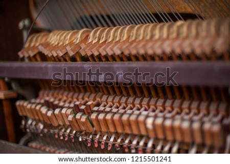 Close-up of an old dusty broken upright piano keyboard at workshop