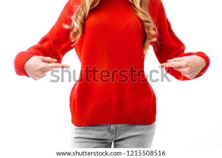 Closeup of a hand, a woman in a red Christmas sweater, pointing to a sweater with fingers. on a white background