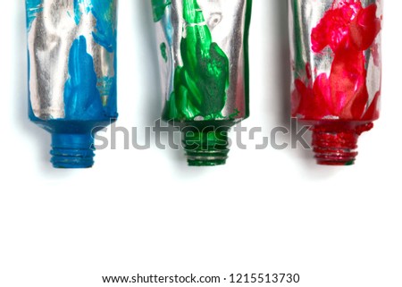 Artistic background. Acrylic paint tubes isolated on white background with copy space.