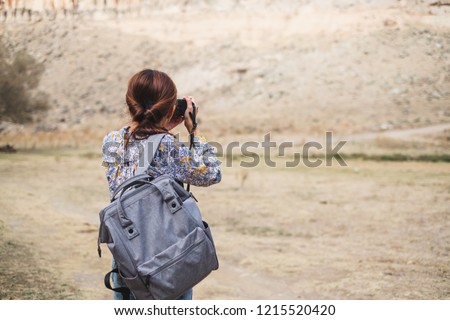 Back view Asian woman using camera  taking photo for landscape view photography