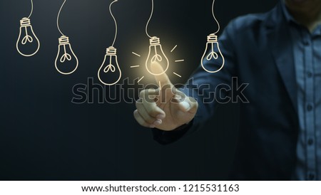Businessman pressing light creative  idea .Concept  idea and innovation