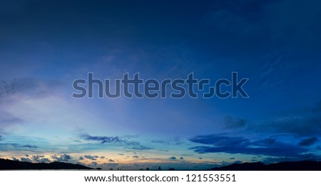 Panorama of night sky clouds above the tropical sea harbor 