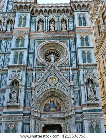 Duomo Florence Cathedral is the third largest church in the world. Italian Renaissance. Architectural details of awesome marble facade with sculptures, painting, rosettes. Italy, Florence 