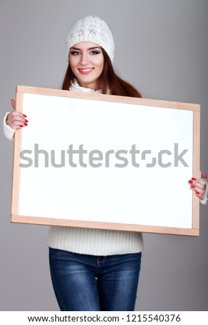 Close up christmas woman portrait behind big white card. Emotion portrait. Isolated.