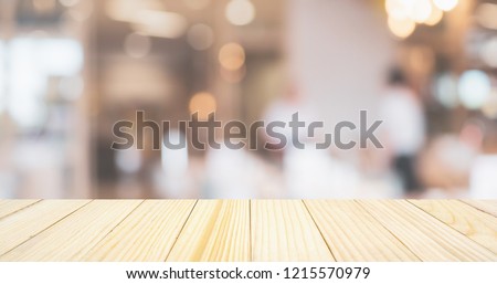 cafe restaurant or coffee shop with abstract bokeh lights defocused blur background with table for product display