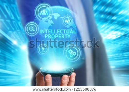 Business, Technology, Internet and network concept. Young businessman working on a virtual screen of the future and sees the inscription: Intellectual property