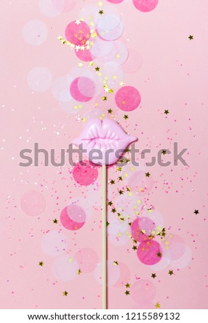 Creative confetti background with pink lips. Bright and festive. Top view, flat lay. Christmas holiday background
