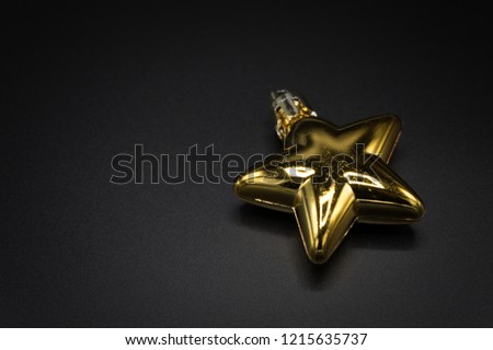 Wallpaper background of gold Christmas decoration object isolated on black background.