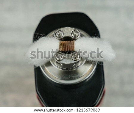 Cotton in coil, in the atomizer for vaping.