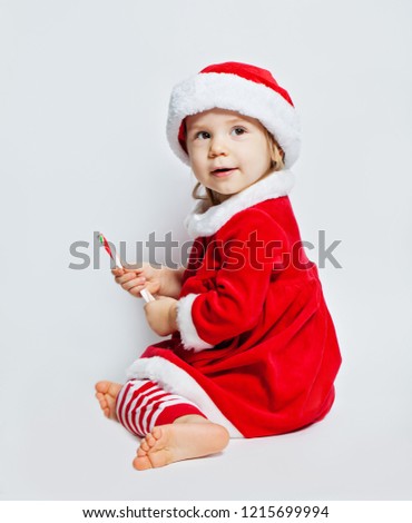 Christmas child in Santa hat on white background