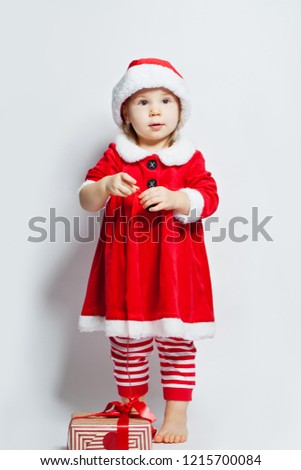 Christmas child girl in Santa hat with Christmas gift box on white background