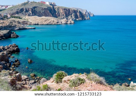 A wonderful day in a beach with waves and rocks in morocco in summer in Al hoceima