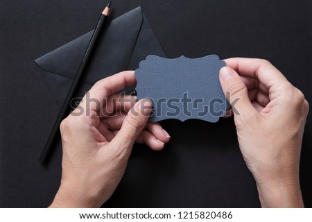 desk top down with hands holding card