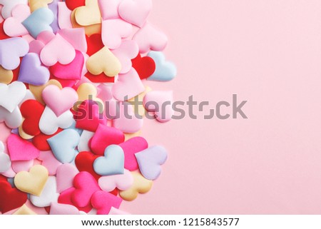 Heap of handmade colorful fabric hearts, valentine's day card, top view Royalty-Free Stock Photo #1215843577