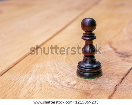 Pawn chess game table black white intelligence strategic pieces. Win piece board wood table.  Ready start standing. Battle checkmate. Challenge outside sunny break. 