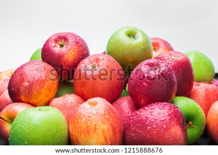 heap of fresh clean green and red apples with drops of water mix on black background, top side view closeup Royalty-Free Stock Photo #1215888676