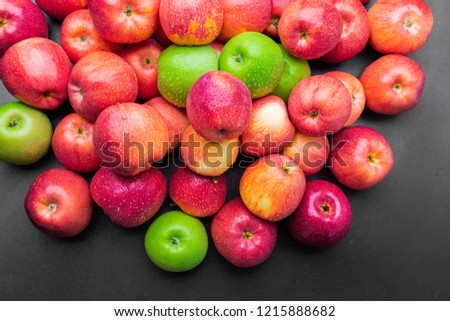 heap of fresh clean green and red apples with drops of water mix on black background, top side view closeup Royalty-Free Stock Photo #1215888682