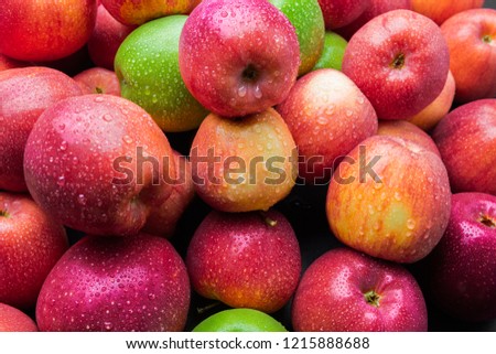 heap of fresh clean green and red apples with drops of water mix on black background, top side view closeup Royalty-Free Stock Photo #1215888688