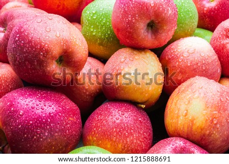 heap of fresh clean green and red apples with drops of water mix on black background, top side view closeup Royalty-Free Stock Photo #1215888691