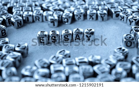 Essay - Word from Metal Blocks on Paper - Concept Photo on Table
