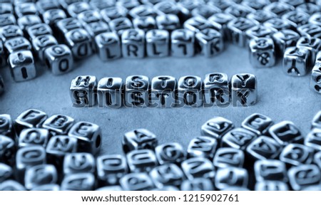 History - Word from Metal Blocks on Paper - Concept Photo on Table
