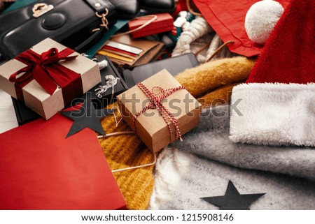 Christmas shopping and seasonal sale. Gift box, credit cards, money, wallet, bags, clothes, jewelry, santa hat, scarf on rustic wood. Space for text. Advertising concept. black friday