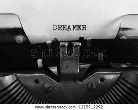 DREAMER, title heading typewritten typed on vintage manual typewriter machine, black and white monochrome, creative concept