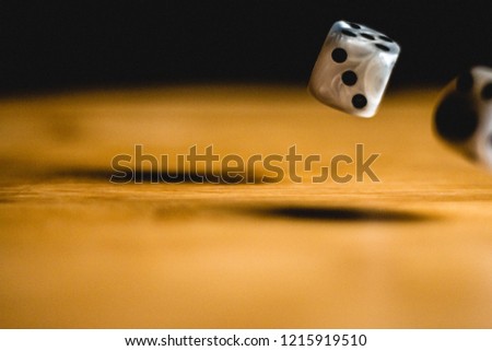 Rolled gambling dices on wooden plank