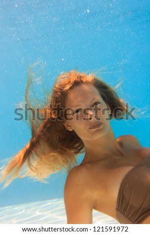 Young woman underwater in the swimming pool
