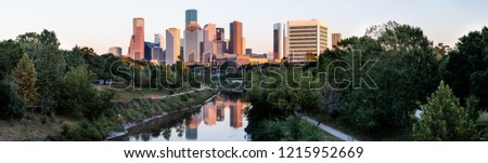 Panoramic view of Houston downtown skyline and reflection in Buffalo Bayou in late afternoon sunlight