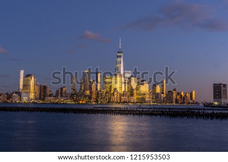 A view of Lower Manhattan from Hoboken New Jersey with the Hudson River in the foreground. Taken during the blue hour.