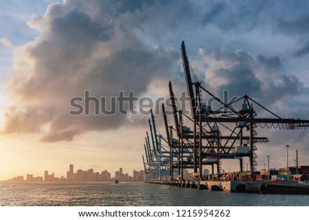 View of cranes of the port of Miami and skyline of downtown Miami at sunset, in Florida, USA Royalty-Free Stock Photo #1215954262