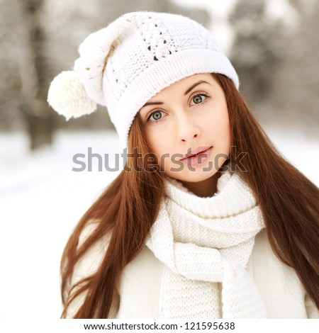 Young beautiful girl in the forest. Winter outdoor portrait.