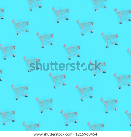 Shopping addiction, shopping lover or shopaholic concept. Many small empty shopping carts perform a pattern on a pastel colored paper background. Flat lay composition, top view