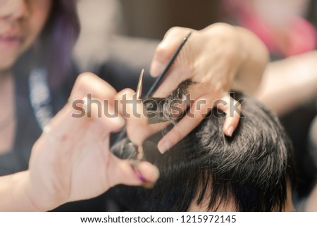 Scissors cut the boy hair. Vintage tone. Close shot. Hair care photo. Royalty-Free Stock Photo #1215972145