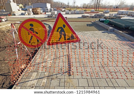 Reconstruction  of pedestrian footpath. Warning signs about road works ahead