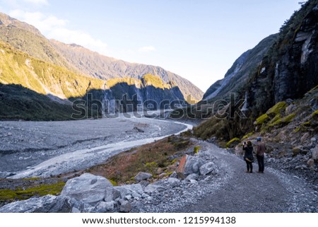 Trail walkway with rocks and river from a glacier. Track: Fox Glacier, New Zealand.