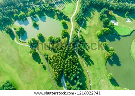Aerial photograph of forest and golf course with lake