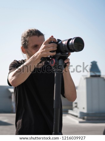 Professional videographer using cinema digital video camera.