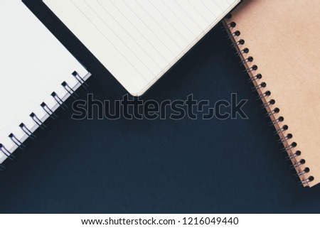 Three notes with white and craft papers on a black background. Copyspace.