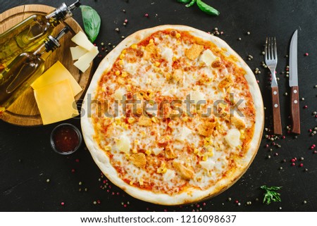 Tasty pizza with ham, corn and cheese on black background