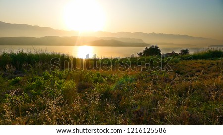 sunrise on the sea coast of the island of Pag in the background of the Velebit mountain, Croatia