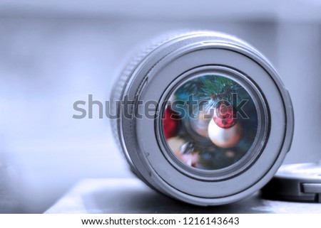 Macro view of professional photograph camera lens,  shoots christmas tree