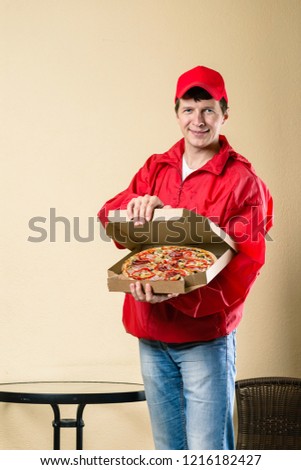 fast food delivery courier, man in red uniform with box